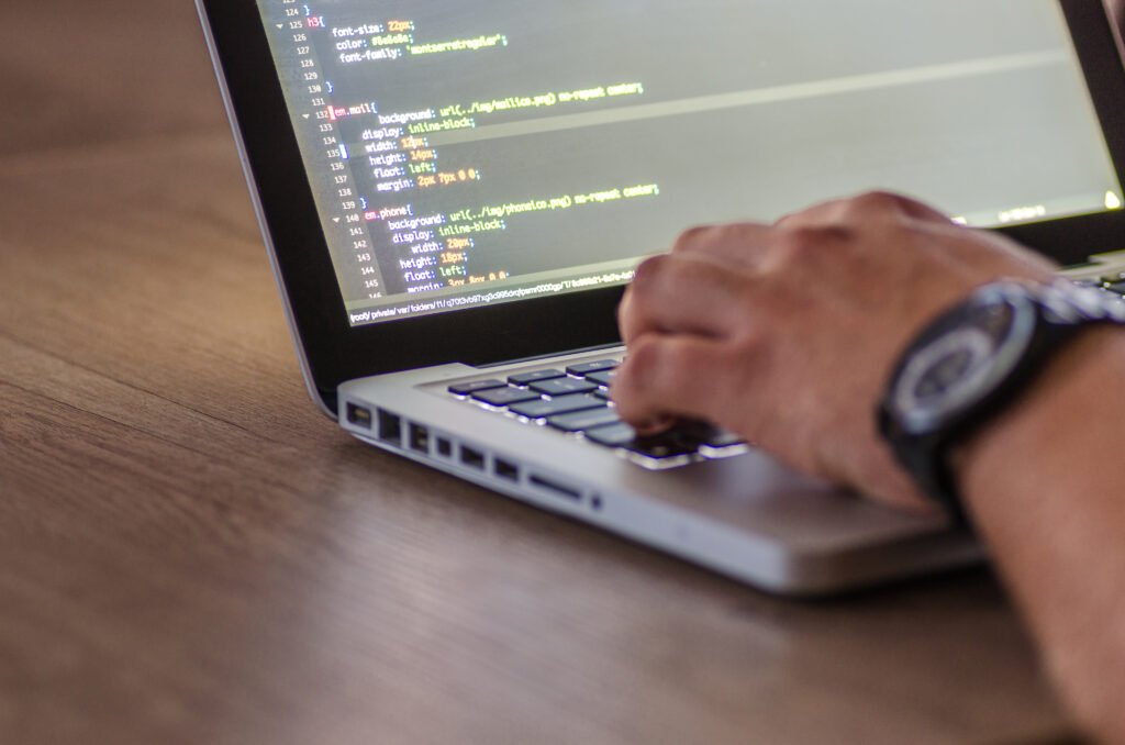 Man coding on laptop